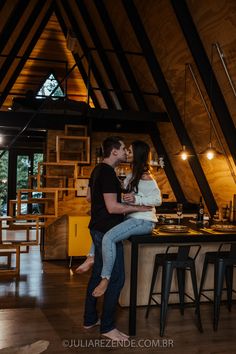 a man and woman are kissing in the kitchen