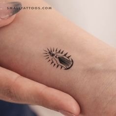 a person with a small tattoo on their arm