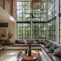 a living room filled with furniture and lots of windows