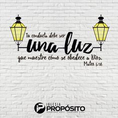 a white brick wall with two yellow lights on it and the words una luze written in