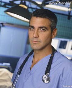 a man in scrubs and a stethoscope standing in a hospital room