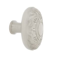 a white door knob with an ornate design on it