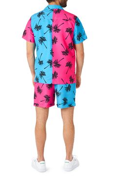 A 2-piece set features a bright and bold palm graphic on a button-up shirt and matching drawstring shorts. 2-piece set Top has notch collar, short sleeves Shorts have elastic drawstring waistband 100% polyester Machine wash, line dry Imported Model stats: 6'1" height, 32" waist. Model is wearing size M. Pink Graphic Print Shorts For Summer, Summer Vacation Pink Hawaiian Shirt, Pink Tropical Camp Shirt For Vacation, Tropical Pink Camp Shirt For Vacation, Multicolor Palm Tree Print Camp Shirt For Beach Season, Summer Graphic Print Short Swimwear, Multicolor Hawaiian Shirt With Palm Tree Print For Summer, Summer Short Swimwear With Graphic Print, Casual Palm Tree Print Swimwear For Spring