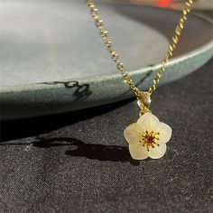 18K gold thick layered over High Quality Solid Stainless Steel. can be worn in water.  Our jewelry is made to last, anti-tarnish, higher durability than a regular gold-plated brass material, perfect for everyday wear. * Finish: 18K Gold * Natural  of Flower , jade white flower necklace with chain * Featuring Adjustable Chain 16.5 inches to 18.5 inches. length: 18.5 inch marterial: 18K Gold pendant width: about 0.51 inch pendant long: about 0.51 inch all items are meatured by handy, if has little size difference,  Please according to the real item size The sample picture is for display only. It can be personalized with any text and symbols. If you have any questions about this, please click on the question button next to the price and I will get right back to you. * All items are nicely pac White Flower Pendant Necklace With Clavicle Chain, White Flower-shaped Gold Plated Jewelry, Dainty White Round Flower Necklace, White Dainty Flower Necklace, Jade Flower Necklace For Gift, White Gold Plated Flower Pendant Jewelry, Jade Flower, Flower Jade, Jade Pendant Necklace