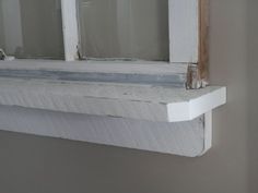 an open window with white paint on the outside and wood trim around the windowsill