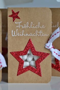 three christmas cards with red glitter stars on them