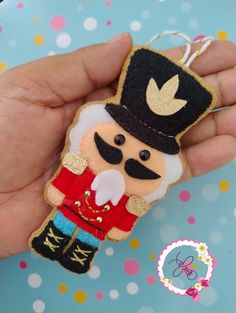 a hand holding a key chain with a nutcracker on it