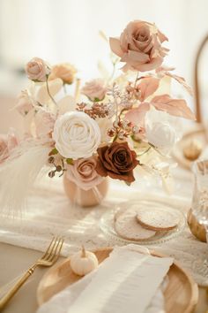 a table topped with flowers and place settings