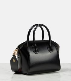 Antigona Toy leather tote bag in black - Givenchy | Mytheresa High-end Black Satchel With Detachable Handle, High-end Crossbody Satchel With Leather Handles, Classic Evening Bags With Leather Handles, Luxury Black Box Bag With Double Handle, Luxury Black Satchel With Double Handle, High-end Leather Handles Shoulder Bag For Evening, Black Business Satchel With Handles, High-end Evening Shoulder Bag With Leather Handles, Luxury Black Double Handle Satchel