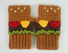 two crocheted oven mitts made to look like owls with eyes and beaks