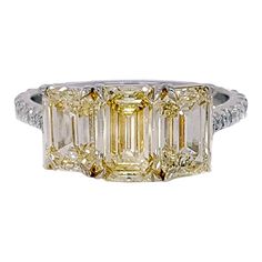 This gorgeous engagement ring features an emerald cut yellow diamond prong set in the center of a three-stone setting, showcasing a 3.35 Carat Yellow Diamond Emerald Cut Three-Stone Engagement Ring, accented by 18 round brilliant diamonds G color, VS clarity weighing approximately 0.36 carat. Set in Platinum and a polished Yellow 18K Gold. This piece was handmade at the Novel Collection Jewelry Atelier, which specializes in rare collectible pieces in the Fancy color diamond. Novel Collection is Diamond Supply, Engagement Rings Platinum, Gorgeous Engagement Ring, Three Stone Engagement, Fancy Color Diamonds, Three Stone Engagement Rings, Rough Diamond, Emerald Cut Diamonds, Three Stone Rings