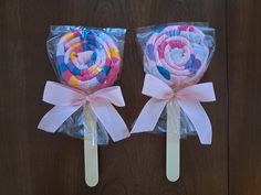 two lollipops wrapped in cellophane and tied with ribbon