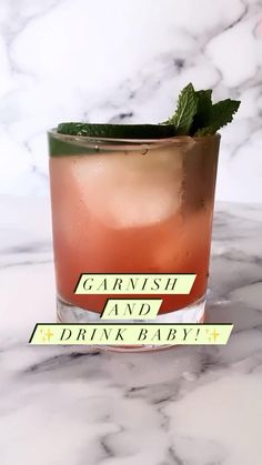 a drink with garnish and a drink baby sticker on it