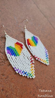 "These handmade author's earrings\" Rainbow Heart LGBT \" are made of high-quality Czech beads and strong synthetic thread.In these unique earrings I use my author's scheme Rainbow Heart LGBT . Color: white,red, orange, yellow, green, blue, purple. Copy without my permission is prohibited For those who want to buy my copyright scheme for these earrings: https://www.etsy.com/uk/listing/847067964/brick-stitch-pattern-for-seed-bead?ref=shop_home_active_1 I will make these earrings for you in your c Pride Beaded Jewelry, Handmade Heart-shaped White Earrings, Handmade White Heart-shaped Earrings, White Heart Drop Earrings For Jewelry Making, White Heart Bead Dangle Earrings, White Heart Beads Dangle Earrings, White Dangle Heart Bead Earrings, White Dangle Heart Earrings With Beads, White Heart Beads Drop Earrings