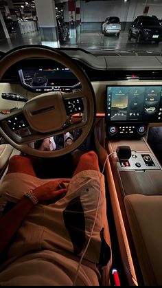 the interior of a car with dashboard, steering wheel and touchscreens on display