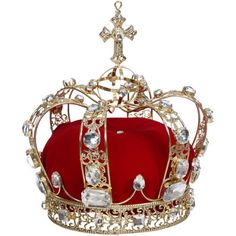 a gold crown with red velvet and crystal stones