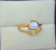 Solid Gold Natural Rainbow Moonstone  Ring - Handmade Oval Gold Ring - Textured gold ring 9K,10K,14k,18K,22K Stone Size  - 6X8 MM  Width - 2 mm  Thickness - 1.2 mm   Gold Colour Options -  Yellow Gold, White Gold, Rose Gold  Ready to Ship 1-2 week Available  White, Yellow, Rose Gold ( also in 9K, 10K, 14K, 18K, 22K ) Customization is available, I also can make it with 9k,10k,14k,18k,22k solid gold (white or rose), and diamond accent stone, just feel free to contact me. Any questions, just let me Handmade 14k Gold Oval Moonstone Ring, Handmade Oval Moonstone Ring In 14k Gold, Yellow Gold Oval Cabochon Moonstone Ring, Oval Hallmarked 14k Gold Moonstone Ring, Yellow Gold Moonstone Oval Cabochon Ring Gift, Gold Cabochon Moonstone Ring Collectible, Luxury Gold Moonstone Cabochon Ring, 14k Gold Moonstone Ring Gift, Oval Cabochon, Textured Gold Ring