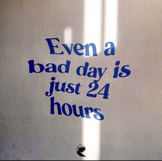 there is a sign that says even a bad day is just 24 hours on the wall