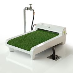 an artificial bed with grass on the bottom and water hose attached to it, in front of a white background