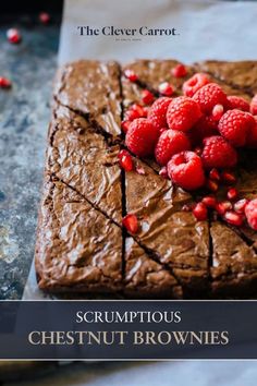 a close up of a chocolate cake with raspberries on top and the words scrumptious chestnutnut brownies