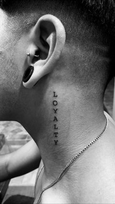 a man with a tattoo on his neck has the word lucky written in black ink