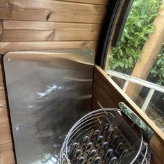 a metal grate sitting on top of a window sill next to a potted plant