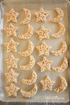 homemade rice krispy treats in the shape of stars and moon on a baking sheet