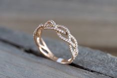 a diamond ring sitting on top of a wooden table