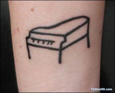 a small black and white drawing of a toaster on the left forearm tattoo design