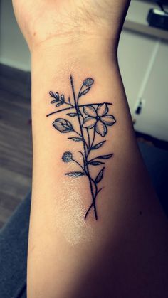 a woman's arm with a flower tattoo on the left side of her body