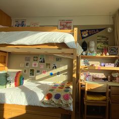 a bedroom with bunk beds and desks in it