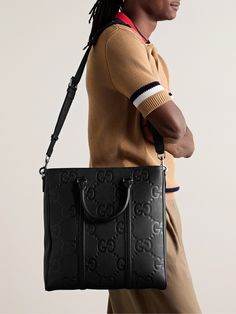 Gucci's tote bag is debossed with the label's iconic 'Jumbo GG' motif, a brand signature since the 1960s that pays tribute to founder Guccio Gucci. Crafted from full-grain leather, it's ideal for carrying your work essentials, like a laptop and notebook, and has a centre zipped pocket for chargers. Gucci Tote Bag Black, Gucci Coated Canvas Bag With Logo, High-end Black Gucci Shoulder Bag, High-end Gucci Tote Bag, Tom Ford Bag, Gucci Tote Bag, Gucci Black Bag With Gold-tone Hardware, Guccio Gucci, New Bottega