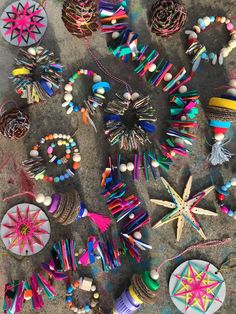 many different items are laying out on the ground with beads and other things around them