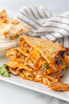 a white plate topped with two quesadillas