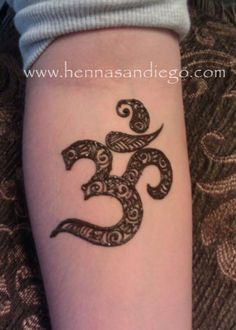 a woman's arm with a tattoo that has an omen symbol on it