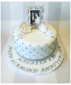 a wedding cake with a picture frame on top