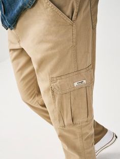 COMFORT AND FUNCTION GUARANTEED Whether you're taking a stroll around the city or headed for a hike, you need pants that can easily transition between activities. That's where Wrangler® cargo pants come in. Our elastic waist cargo pants were created for comfort, function, and style to provide a versatile solution that will last you from day to night. As you move or rest, the flex waistband expands with you to keep you feeling comfortable and free all day long. The men's comfort waist cargo pants are made of breathable cotton and come with plenty of pocket space for your essentials. Not only do you have two large cargo pockets, but you also have a hidden tech pocket for your mobile device. With Wrangler® cargo pants, you're ready for anything. Casual Cargo Pants With Hip Pockets For Hiking, Casual Hiking Bottoms With Patch Pockets, Casual Cargo Pants For Hiking, Casual Straight Leg Cargo Pants For Hiking, Casual Relaxed Fit Cargo Pants For Hiking, Casual Hiking Bottoms, Wrangler Cargo Pants, Waist Cargo Pants, Wrangler Pants