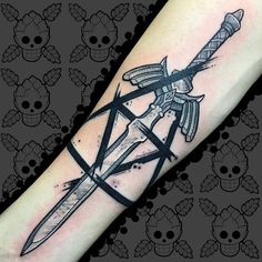 a black and white tattoo on the arm of a person with a knife in it