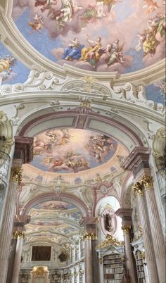 the interior of an old church with painted ceilings and murals on the ceiling, along with columns