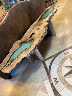 a wooden bench sitting on top of a tiled floor