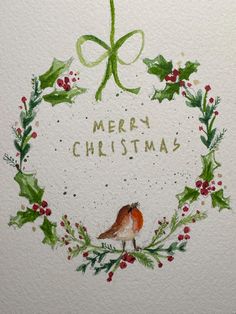 a watercolor drawing of a christmas wreath with holly and a bird on the front