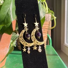 Mystical Gold Moon Phase Earrings, Magical Gold Metal Jewelry, Magical Gold Jewelry For Festival, Gold Crescent Spiritual Earrings, Magical Gold Nickel-free Jewelry, Bohemian Gold Moon Phase Earrings, Gold Moon-shaped Festival Jewelry, Celestial Crescent Earrings With Star Charm, Celestial Metal Jewelry With Dangling Charms