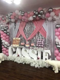 a decorated dessert table with balloons and cake