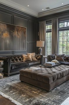 a living room filled with furniture and a large painting hanging on the wall above it