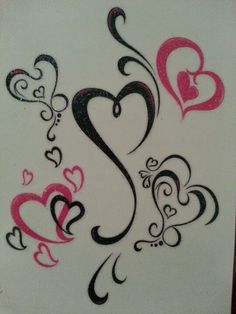 some hearts are drawn on a piece of paper with black and pink ink in it