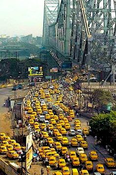 a busy city street filled with lots of yellow cabs