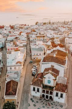 an aerial view of a city with lots of white buildings