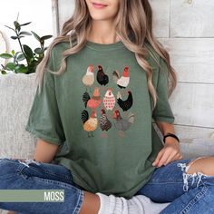 Add some fun to your wardrobe with this cute Chicken Print T-Shirt! Perfect for those who adore farm animals, this tee features a cute array of chickens in various patterns and poses. The playful design is screen printed on a high-quality, soft fabric, making it a comfortable and stylish choice for everyday wear. Whether you're running errands or visiting a local farm, this unisex shirt is sure to get you compliments from fellow poultry enthusiasts. Available in multiple sizes to ensure a good f Vintage Chicken, Chicken Mom, Cute Chicken, Chicken Print, Cute Chickens, Local Farm, Mama Shirts, Fabric Making, Conscious Fashion