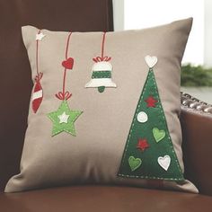 a christmas tree pillow sitting on top of a couch