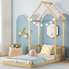 a child's bed with a wooden frame and canopy in a blue walled room